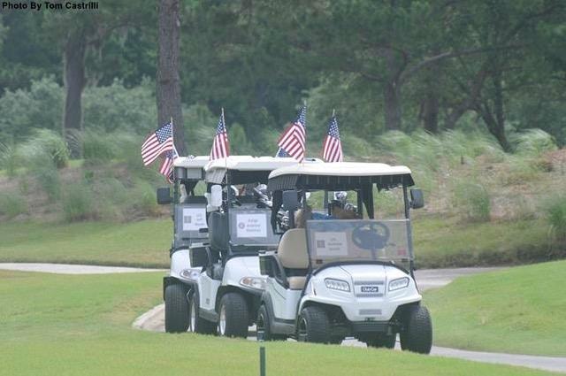 Golf carts decorated with American flags on the course