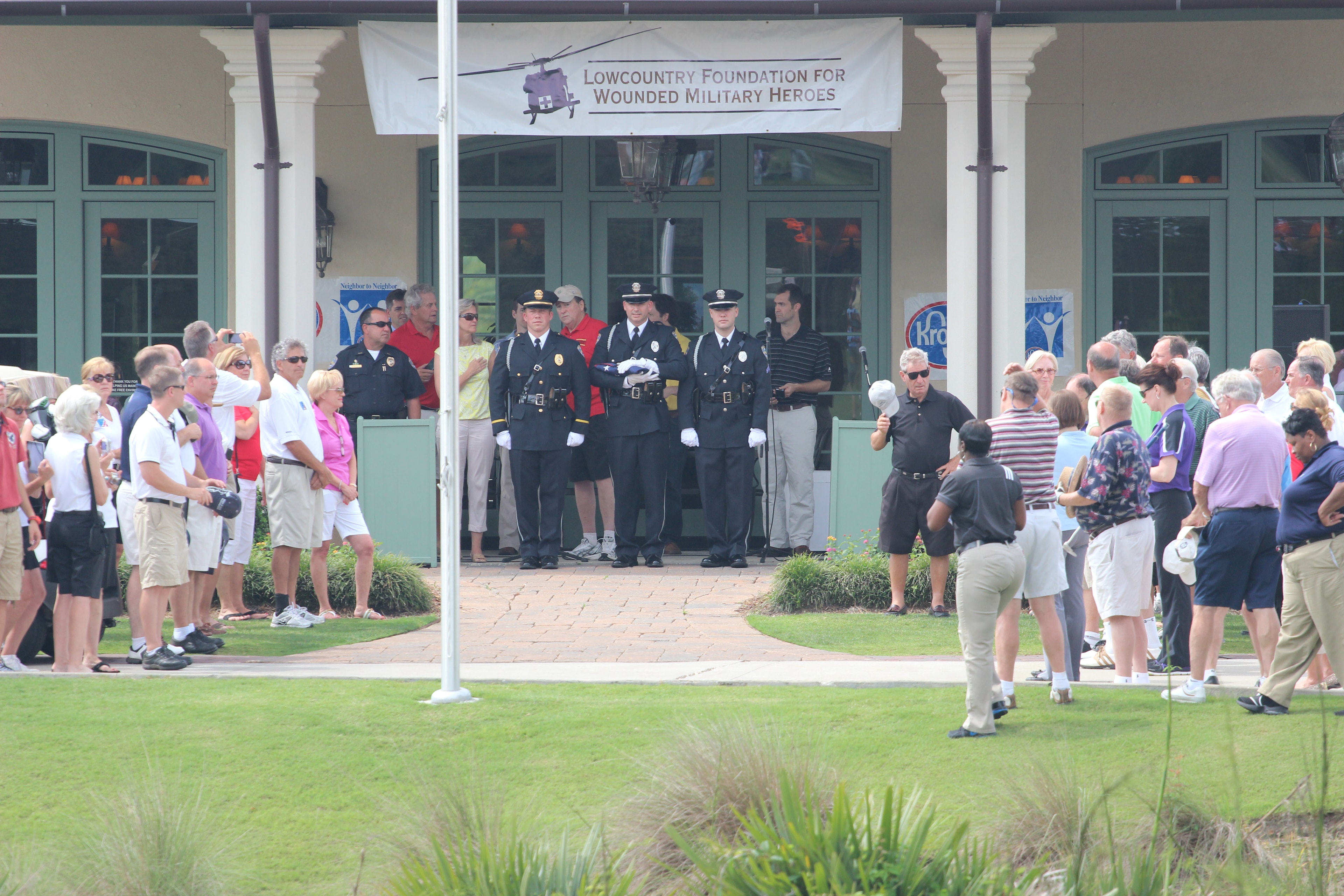 Opening ceremonies at the Golf Classic with color guard and crowd